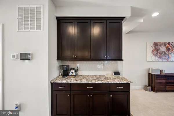 a kitchen with a table chairs stove and refrigerator