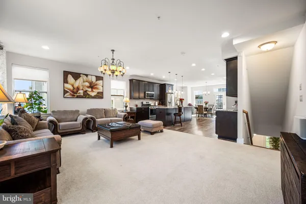 a living room with furniture and a chandelier