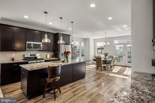 a kitchen with a refrigerator a sink dishwasher stove and oven