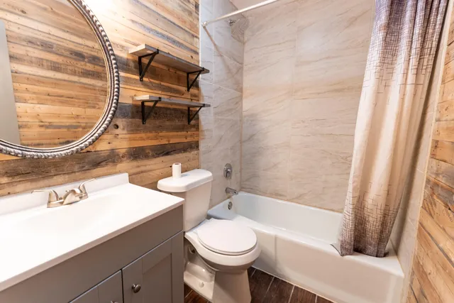 a bathroom with a toilet a sink and bathtub
