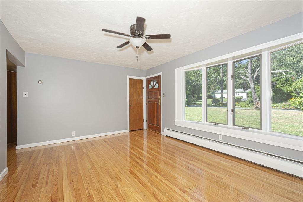 107 Ponakin Road Lancaster, MA 01523 - Photo 14 of 33 a view of an empty room with wooden floor and a window