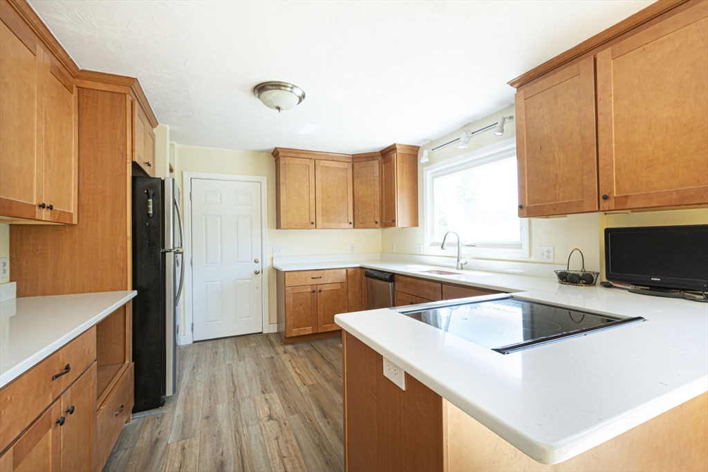 107 Ponakin Road Lancaster, MA 01523 - Photo 18 of 33 a kitchen that has a sink cabinets counter space and a window