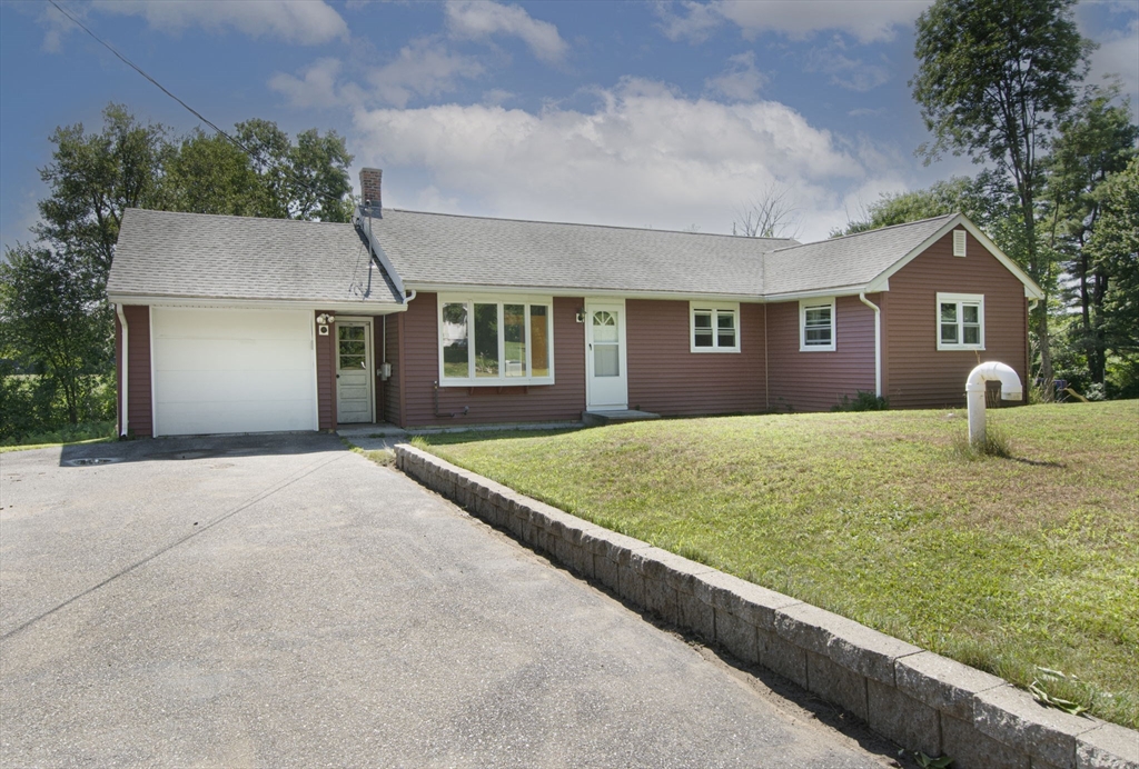 107 Ponakin Road Lancaster, MA 01523 - Photo 3 of 33 a front view of a house with garden