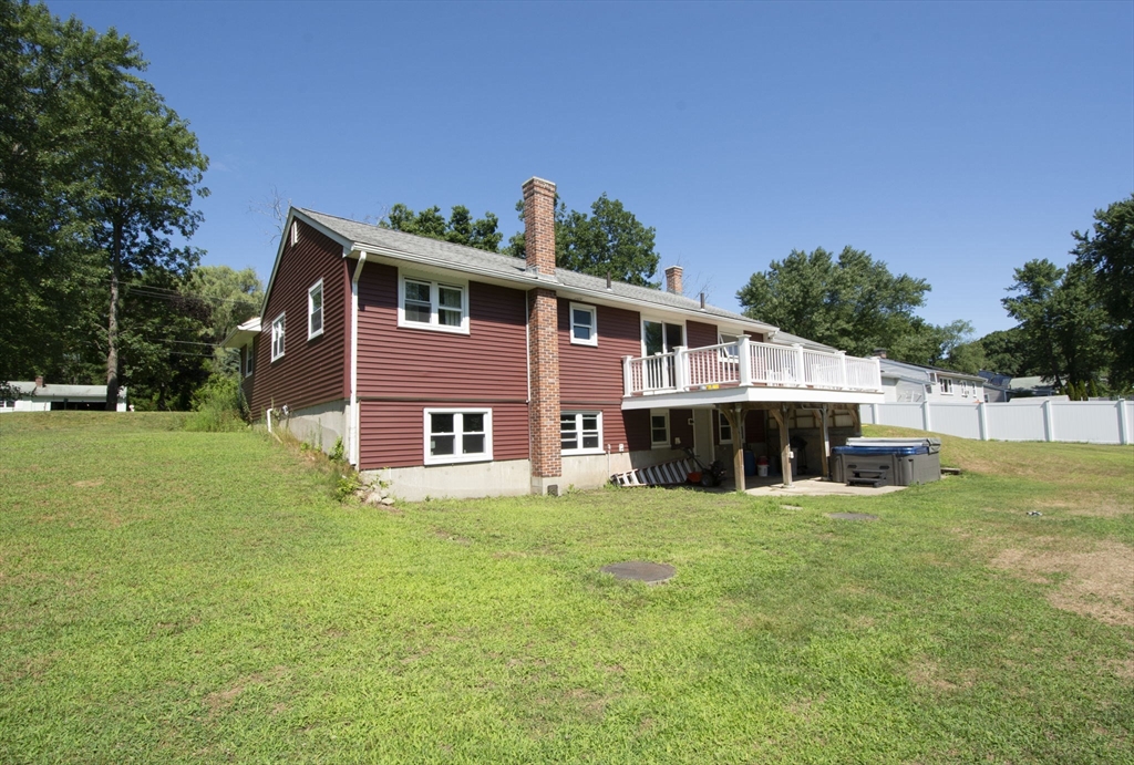 107 Ponakin Road Lancaster, MA 01523 - Photo 4 of 33 a view of a house with a big yard and large trees