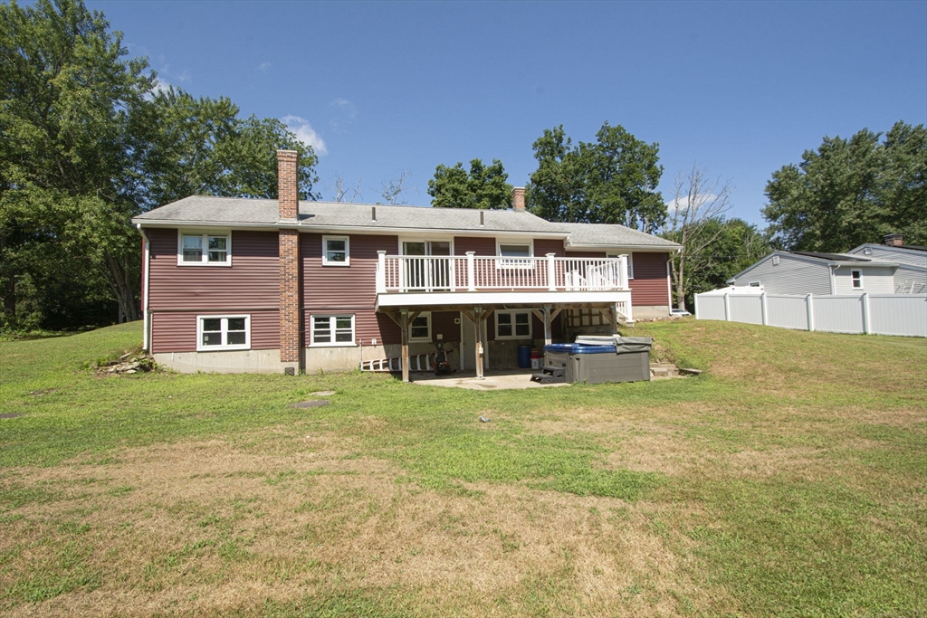 107 Ponakin Road Lancaster, MA 01523 - Photo 5 of 33 a view of a house with a big yard and large trees