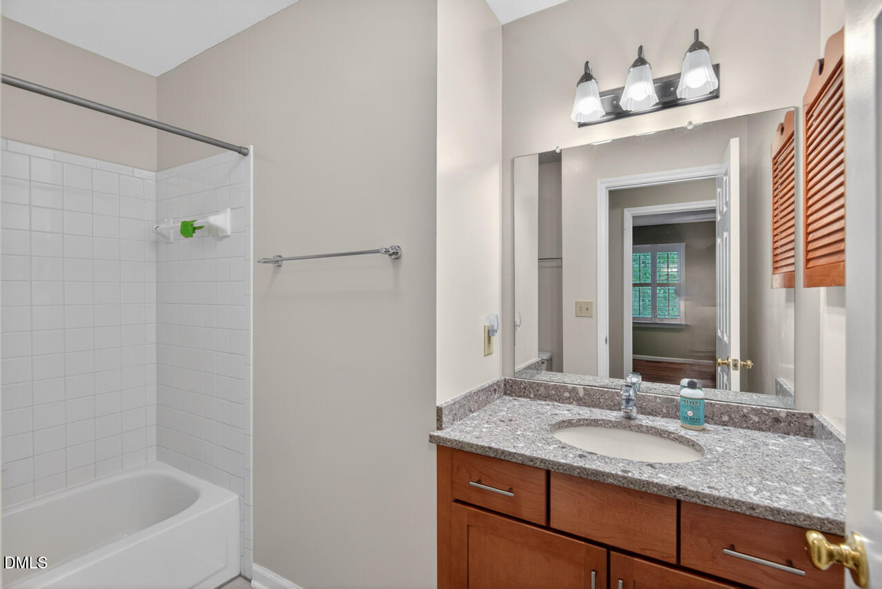 3307 Coachman's Way Durham, NC 27705 - Photo 39 of 50 a bathroom with a granite countertop sink and a mirror