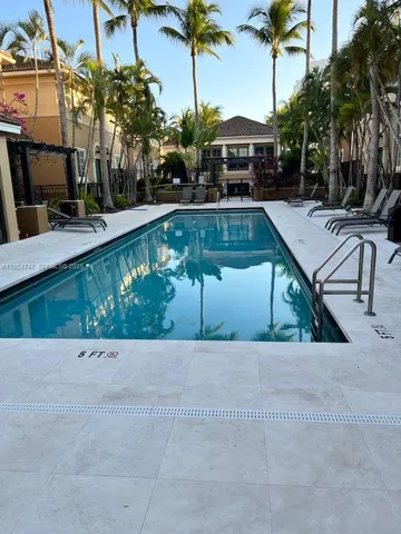 a view of staircase with lots of frames on wall and a potted plant