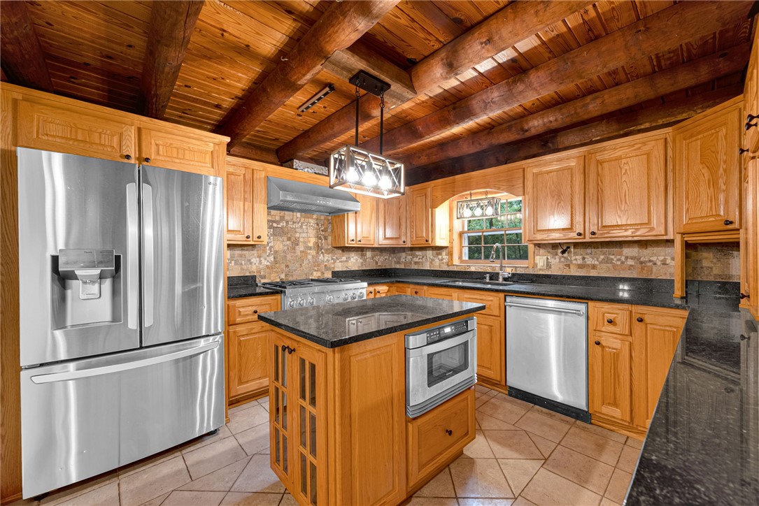 237 Spring Valley Road Liberty, SC 29657 - Photo 8 of 50 A rustic-chic kitchen features natural wood cabinetry and a full suite of stainless steel appliances.
