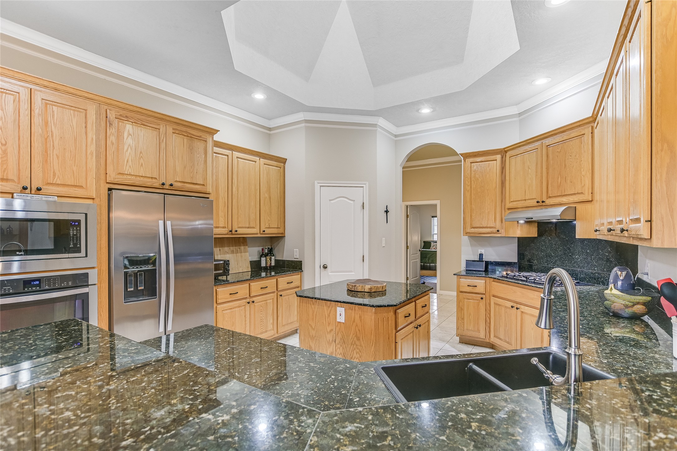 741 Knobbs Road McDade, TX 78650 - Photo 11 of 38 Granite counters and stainless steel appliances adorn this well-lit kitchen, boasting a central island.