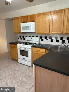 a kitchen with stainless steel appliances a stove sink and cabinets