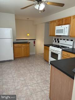 220 Ryers Avenue Cheltenham, PA 19012 - Photo 6 of 19 a kitchen with a stove and a refrigerator
