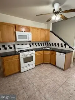 a kitchen with stainless steel appliances a stove a sink and a refrigerator