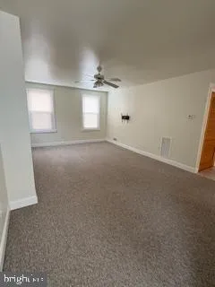 an empty room with windows and closet