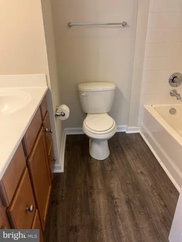 a white toilet sitting next to a white sink
