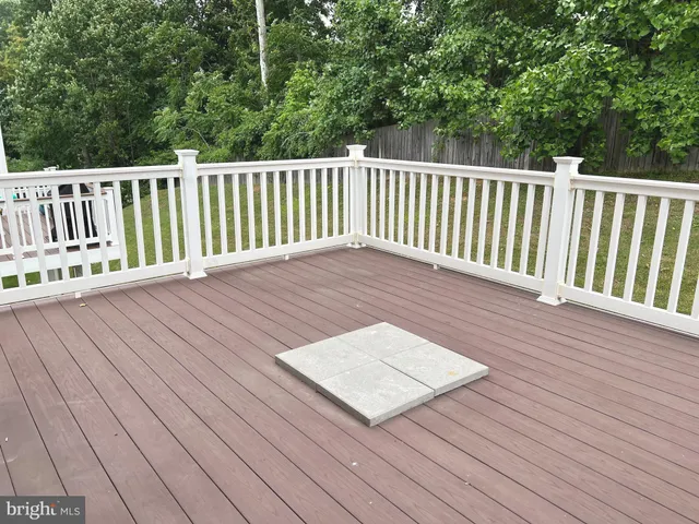 a terrace with wooden floor and fence
