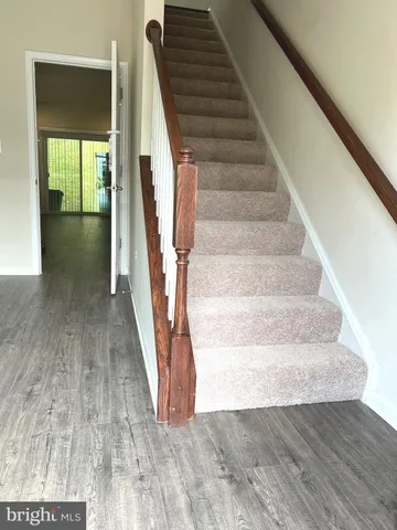 a view of entryway and hall with wooden floor