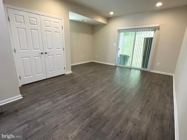 an empty room with wooden floor