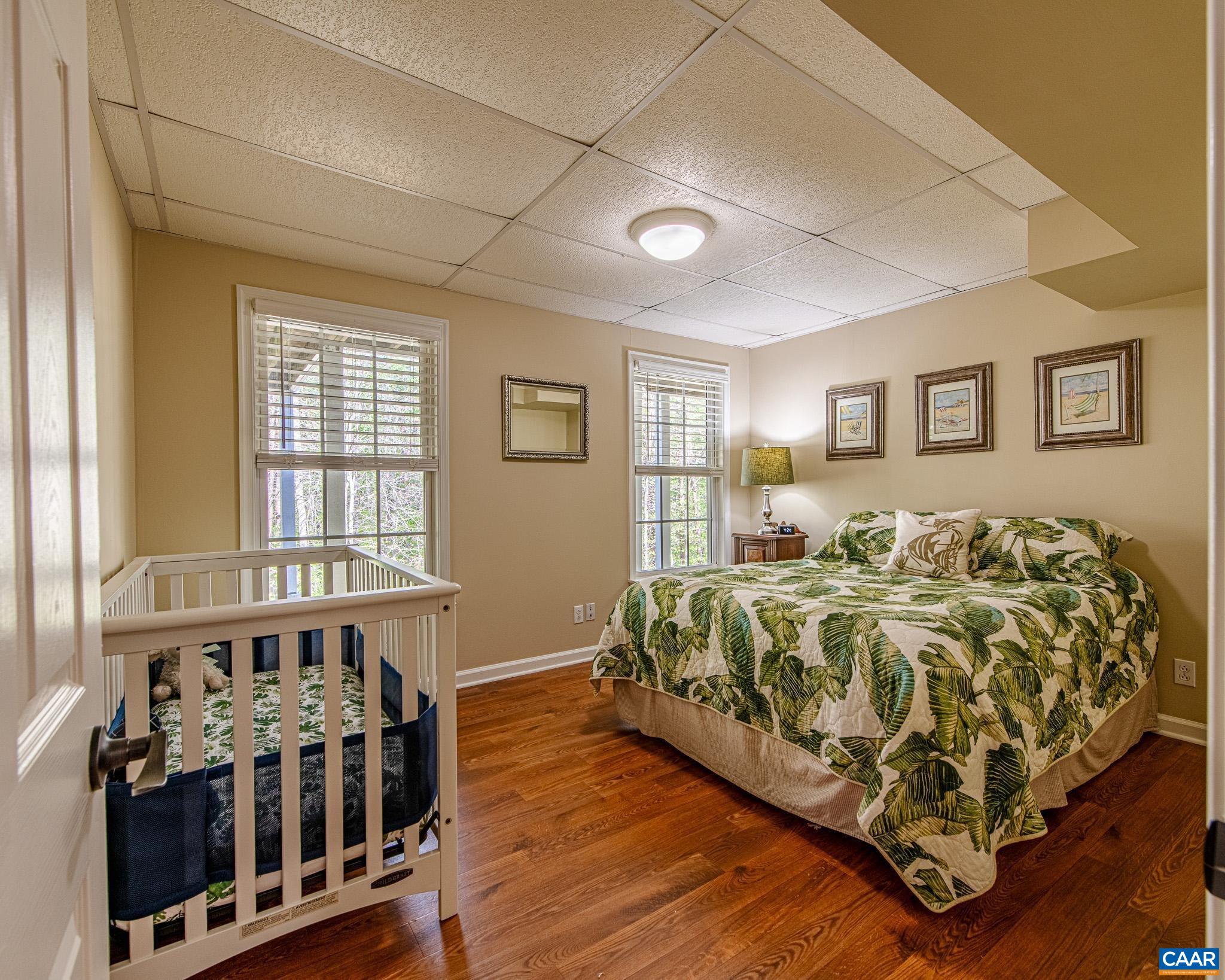 1089 Broken Island Road Palmyra, VA 22963 - Photo 53 of 74 a bed sitting in a bedroom next to a window with wooden floor