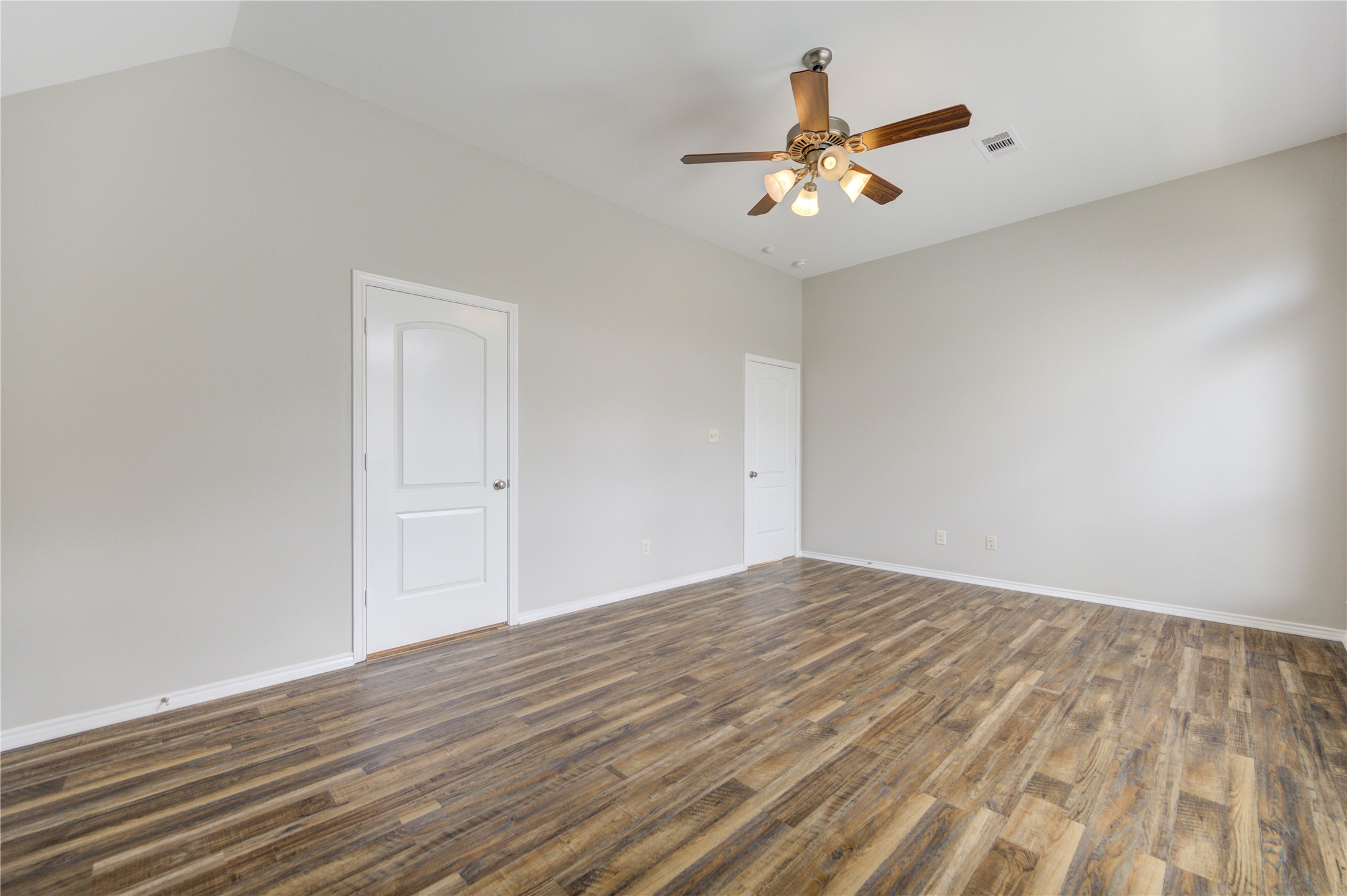 27407 Gatlin Lane Spring, TX 77386 - Photo 23 of 35 The spacious primary bedroom offers a quiet retreat with soaring ceilings, generous proportions, and plenty of room to create your own private sanctuary.
