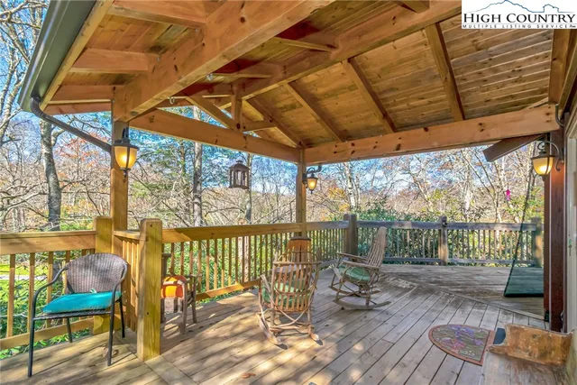 a balcony with chairs and wooden floor