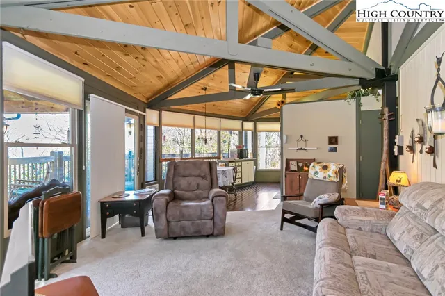 a living room with furniture and a floor to ceiling window