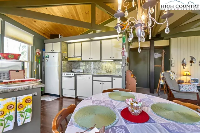 a kitchen with stainless steel appliances granite countertop a sink a refrigerator and a stove