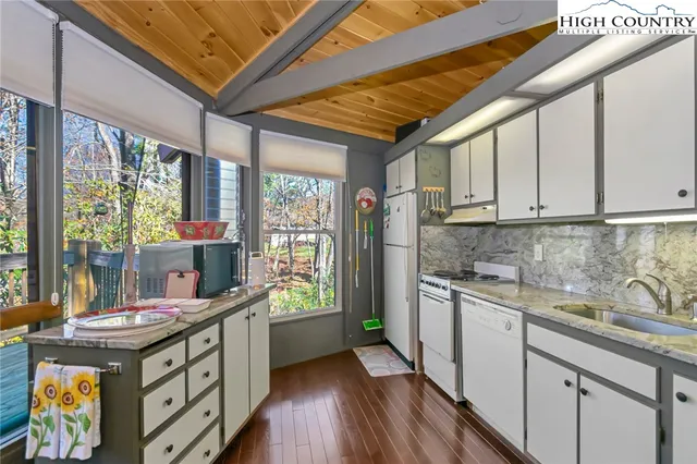 a kitchen with sink a stove and cabinets