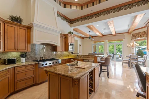 a kitchen with stainless steel appliances a sink stove and cabinets