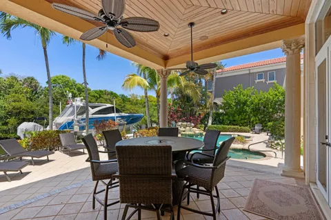 a view of a house with backyard water fountain and sitting area