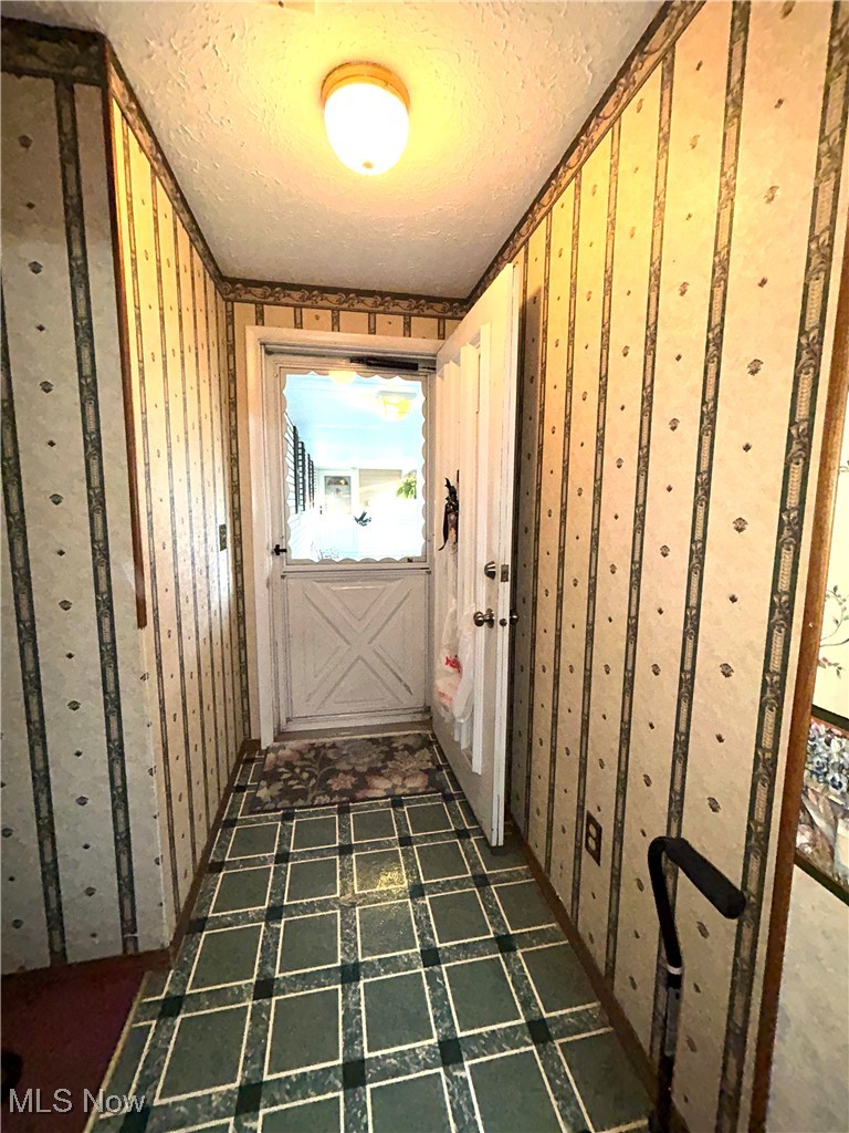8753 West Ridge Road, Unit A Elyria, OH 44035 - Photo 3 of 21 Hall with a textured ceiling and wallpapered walls