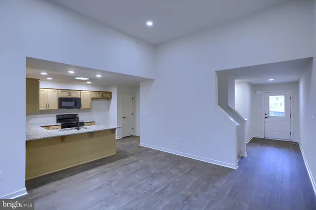 a view of kitchen with cabinets and wooden floor