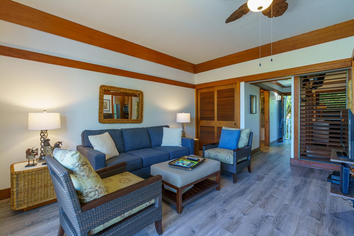 a living room with furniture and a wooden floor