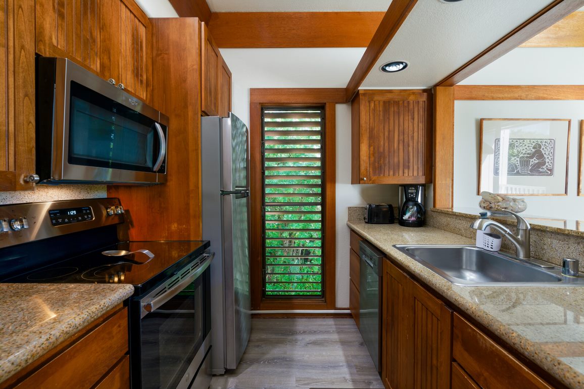 2253 Poipu Road, Unit 407 Koloa, HI 96756 - Photo 6 of 8 a kitchen with a sink stove top oven and microwave