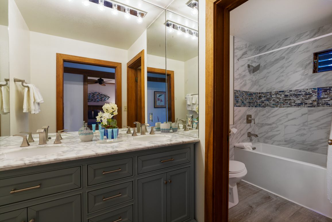 2253 Poipu Road, Unit 407 Koloa, HI 96756 - Photo 8 of 8 a bathroom with a granite countertop sink mirror and a bathtub