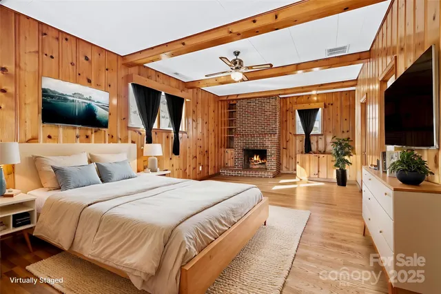 a spacious bedroom with a large bed a flat tv screen and a balcony view