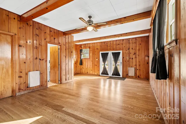 a view of front door with wooden floor and stairs
