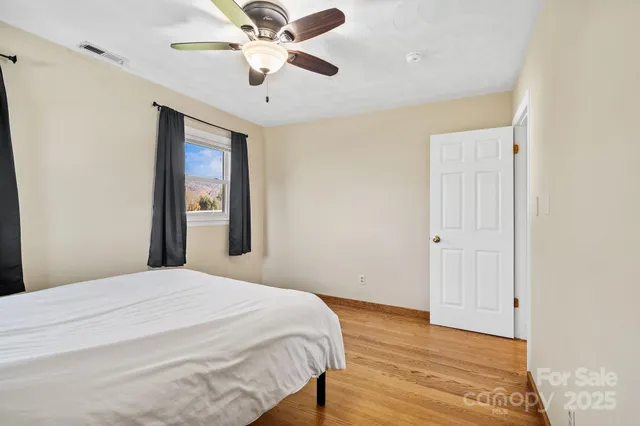 a bedroom with a large bed and a chandelier