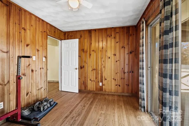 a view of a room with wooden floor and a window
