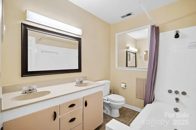 a bathroom with a sink a toilet and a mirror