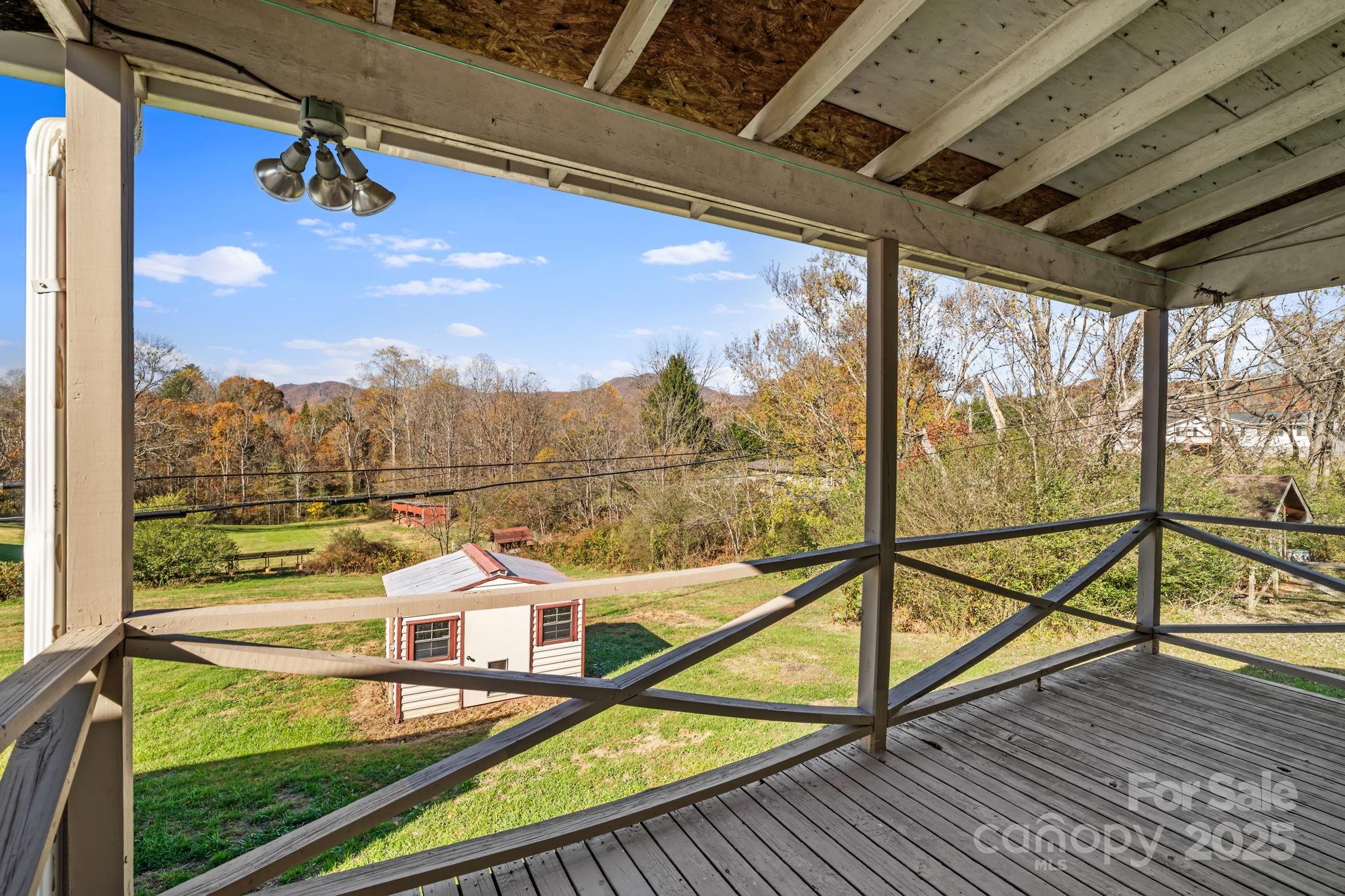 193 Dogwood Road Candler, NC 28715 - Photo 24 of 31 a view of a balcony with chair and wooden floor