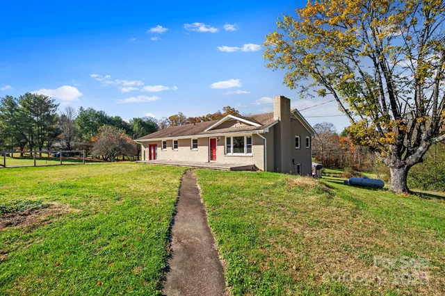 a front view of house with yard and green space