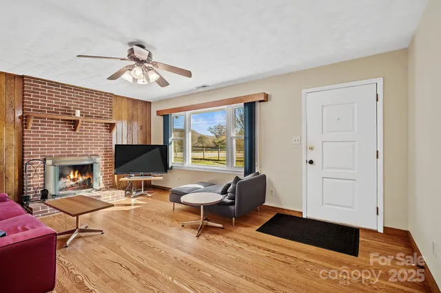 a living room with furniture a fireplace and a window