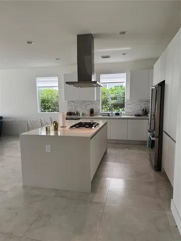 a kitchen with a cabinets and white appliances