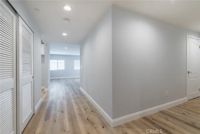 a view of a hallway with wooden floor