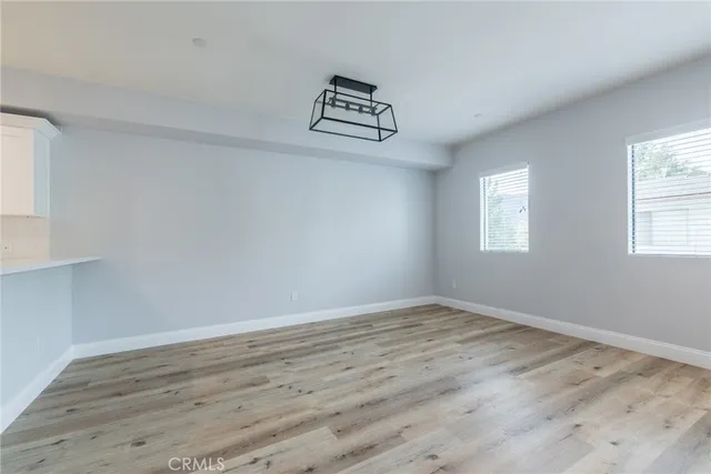 a view of a room with wooden floor and window