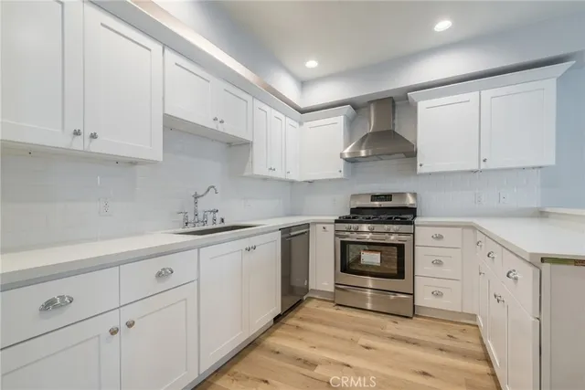 a kitchen with cabinets appliances and a sink