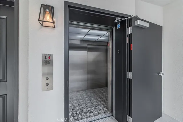 a bathroom with a glass door shower and vanity