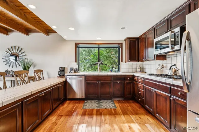 a kitchen with a sink and large window