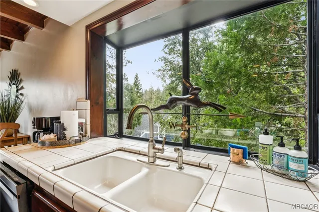 a very nice looking living room with a large window and wooden floor