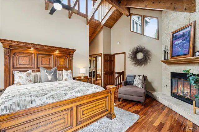 a bedroom with a bed and a large window with outer view